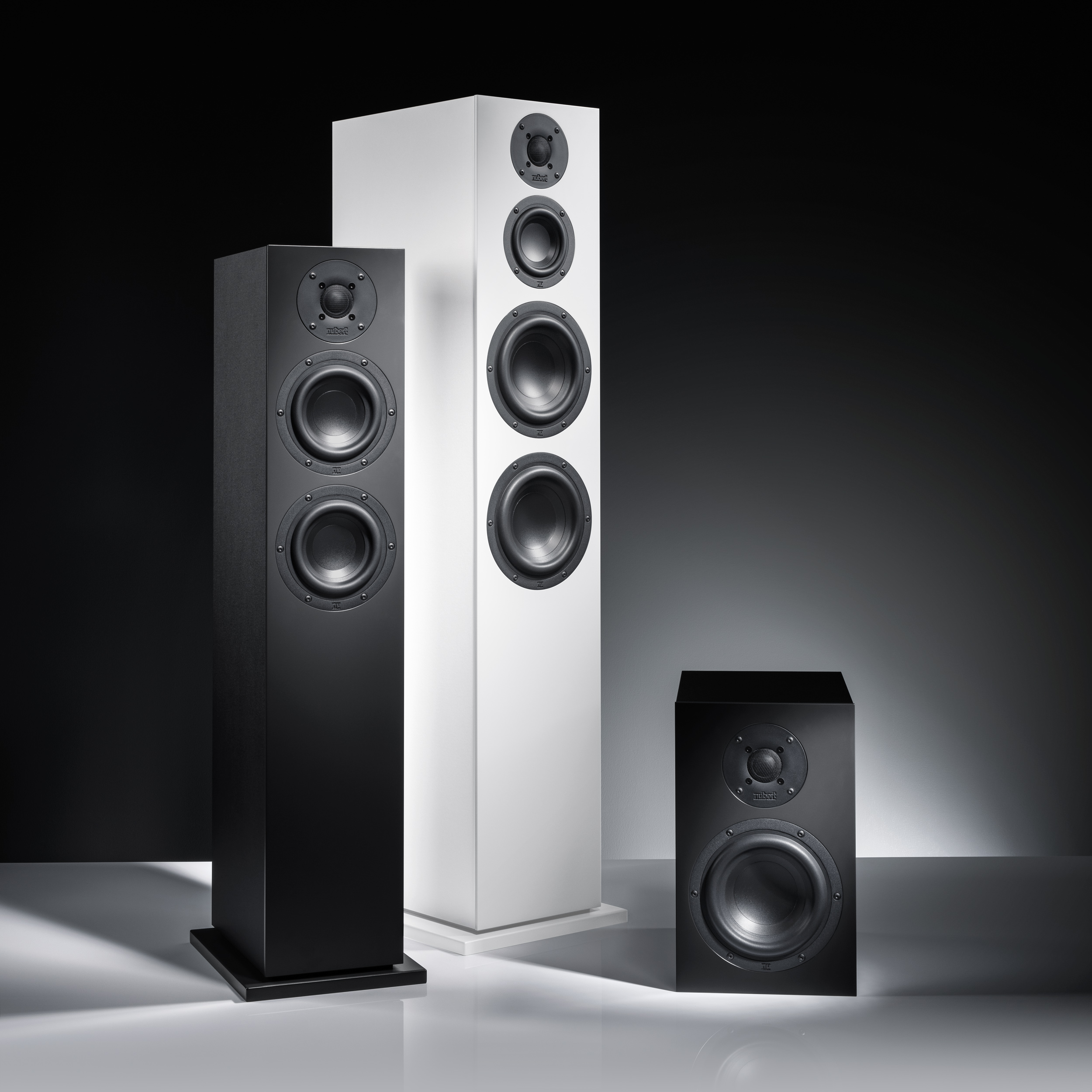 nuBoxx B 40 B 60 B 70 Ambiente nuBoxx speakers in black and white against a dark background.